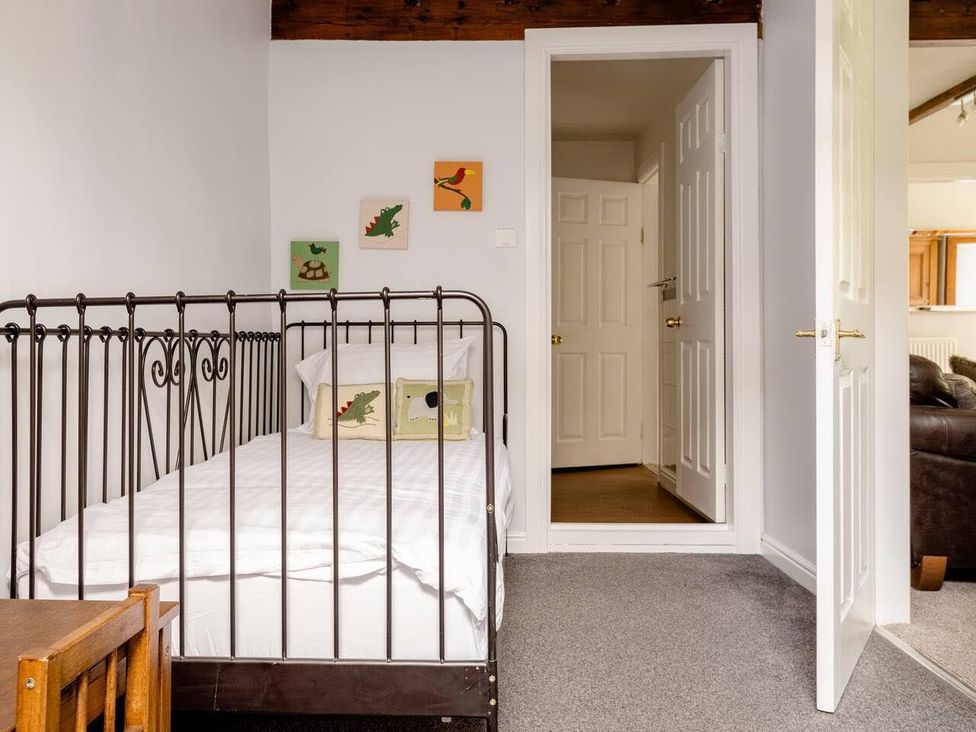 A bedroom with a bed and wall art at OldMill 2Bed Sleeps6 PrivateGarden OptionalHotTub in Oakworth