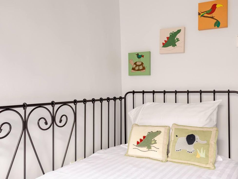 A bedroom with a bed and colorful wall art at OldMill 2Bed Sleeps6 PrivateGarden OptionalHotTub in Oakworth