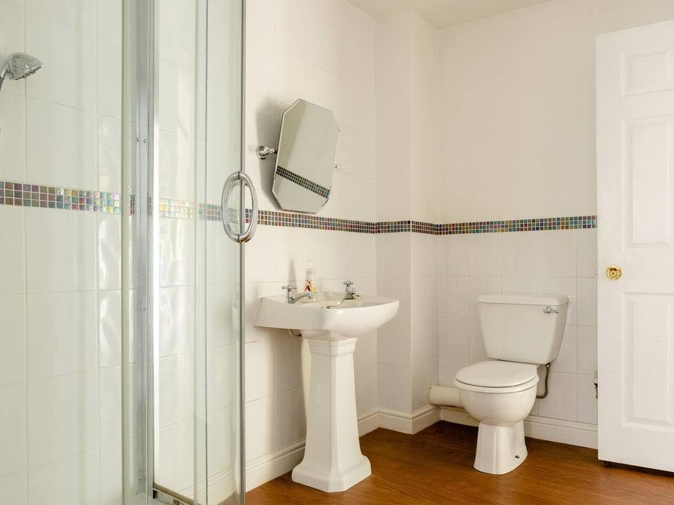 A bathroom with a shower, sink, and toilet at OldMill 2Bed Sleeps6 PrivateGarden OptionalHotTub in Oakworth