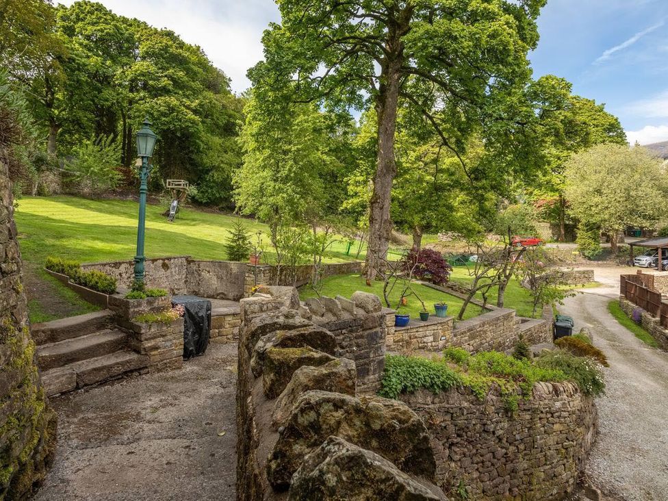 An outdoor garden with trees and a pathway at OldMill 2Bed Sleeps6 PrivateGarden OptionalHotTub in Oakworth