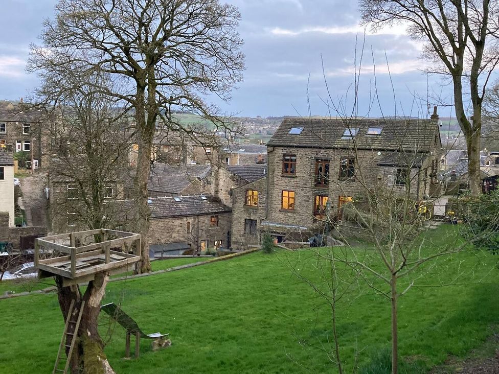 A view of houses and trees from a garden at OldMill 2Bed Sleeps6 PrivateGarden OptionalHotTub in Oakworth