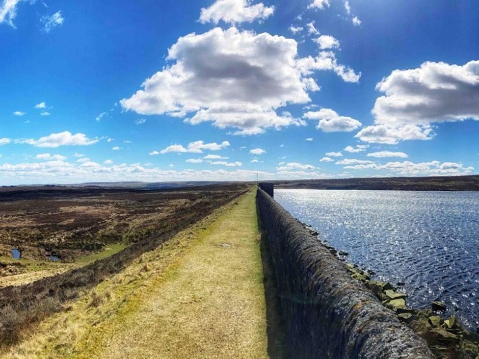 A scenic view of a path alongside water under a blue sky at OldMill 2Bed Sleeps6 PrivateGarden OptionalHotTub, Oakworth