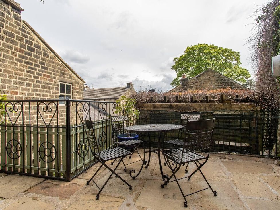 A balcony with a table and chairs at OldMill 2Bed Sleeps6 PrivateGarden OptionalHotTub in Oakworth