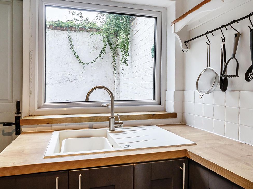 A kitchen with a sink and window at Quaint Cottage in Charming Evesham