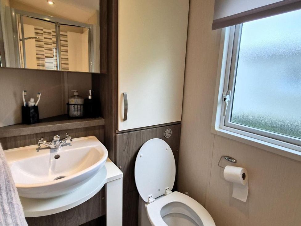A bathroom with sink and toilet at Homely Caravan in Skegness