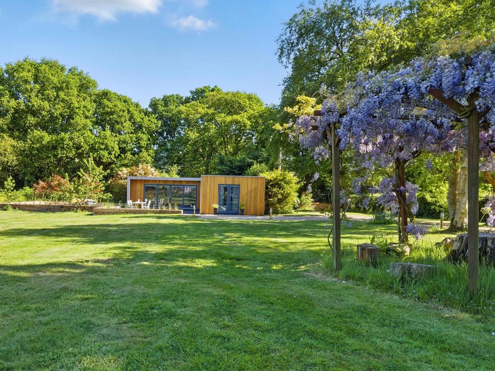 A house with outdoor furniture in the garden at Tyler Hill near Canterbury