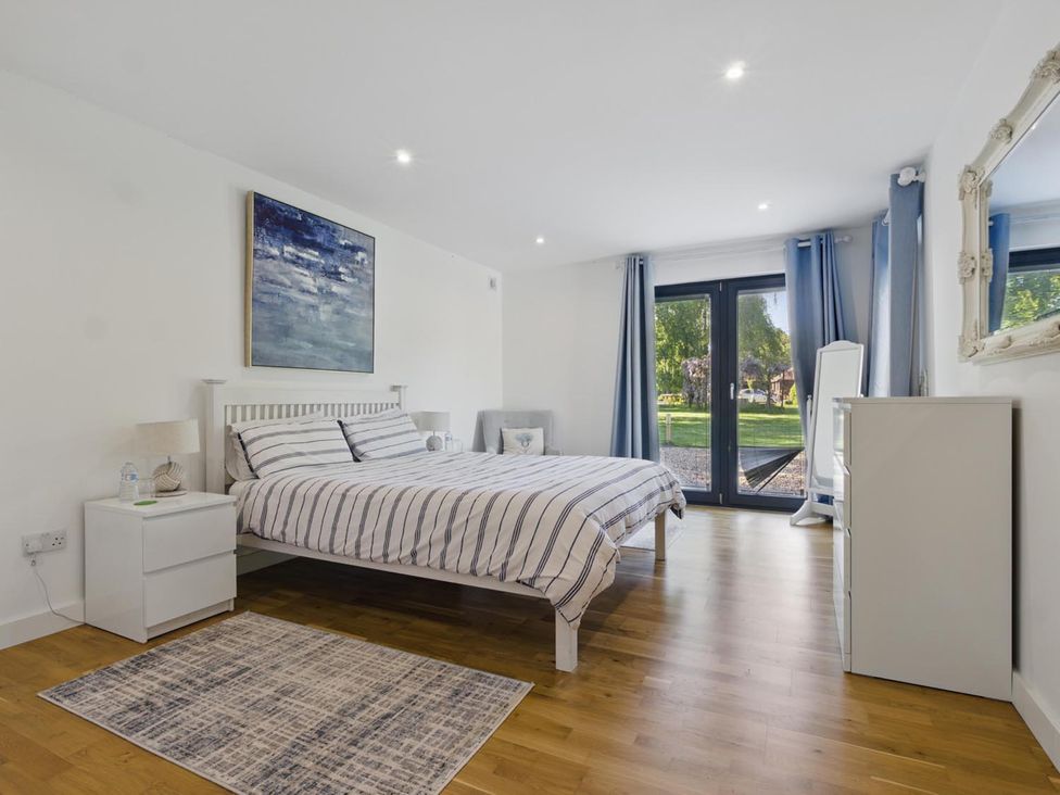 A bedroom with a bed and a nightstand at Tyler Hill near Canterbury