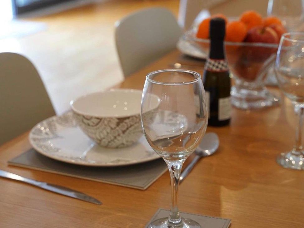 A dining table with a plate, bowl, glass, and fruit at a property in Tyler Hill near Canterbury