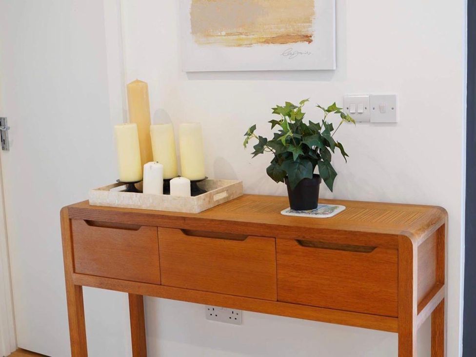 A console table with candles and a plant at a modern home in Tyler Hill near Canterbury