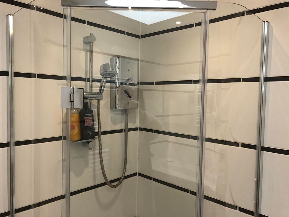 A shower with glass doors and showerhead at 