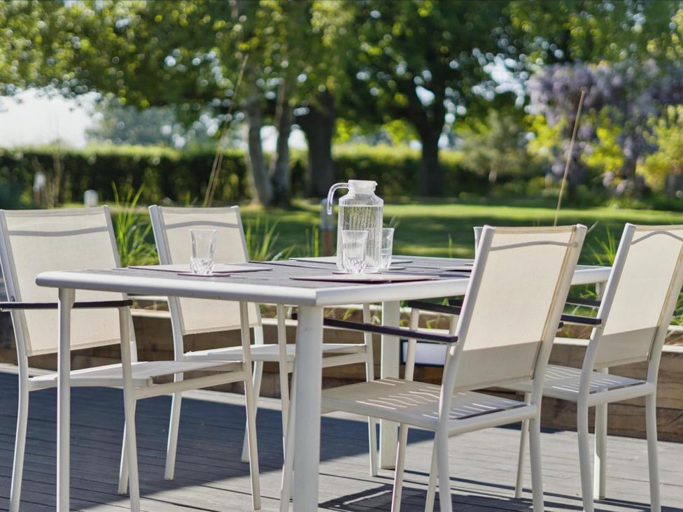 A table with chairs and a pitcher in an outdoor area at 