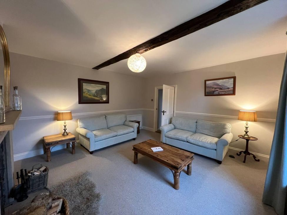 A living room with two sofas and a coffee table at House Sleeps 10 Pet friendly Parking in Caldbeck