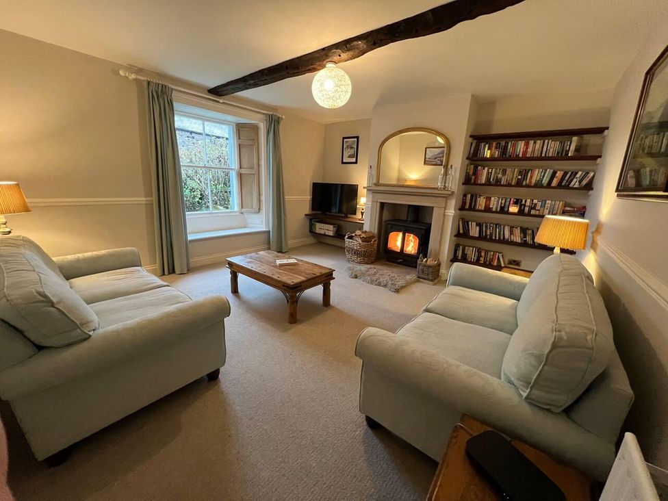 A living room with sofa and fireplace at House Sleeps 10 Pet friendly Parking in Caldbeck