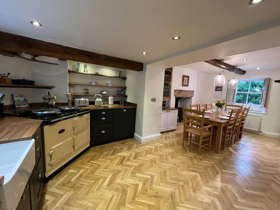A kitchen with a dining area and wooden furniture at House Sleeps 10 Pet friendly Parking in Caldbeck