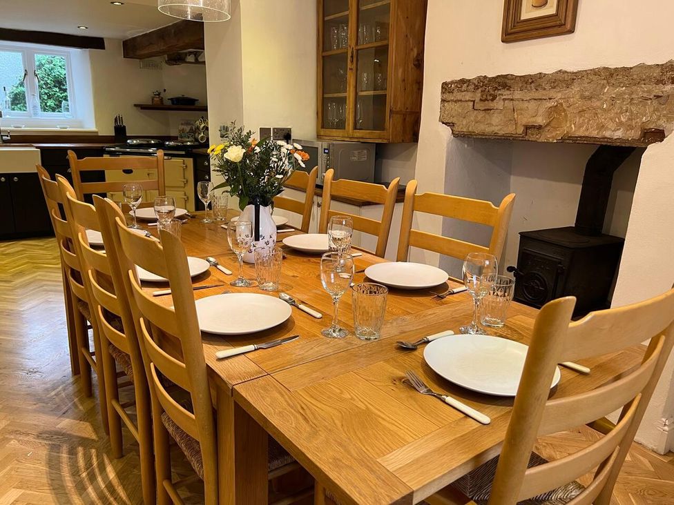 A dining room with a table set for meals at House Sleeps 10 Pet friendly Parking in Caldbeck