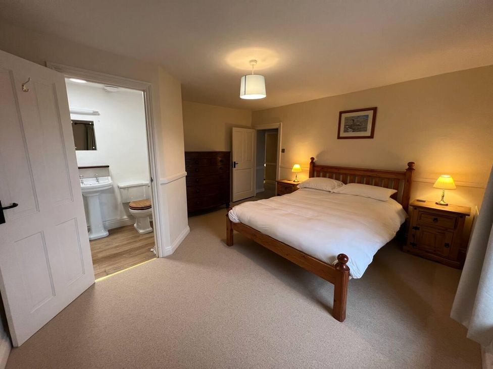 A bedroom with a bed and adjoining bathroom at House Sleeps 10 Pet friendly Parking Caldbeck