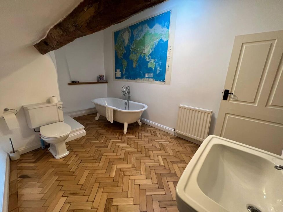 A bathroom with a bathtub and sink at House Sleeps 10 Pet friendly Parking in Caldbeck