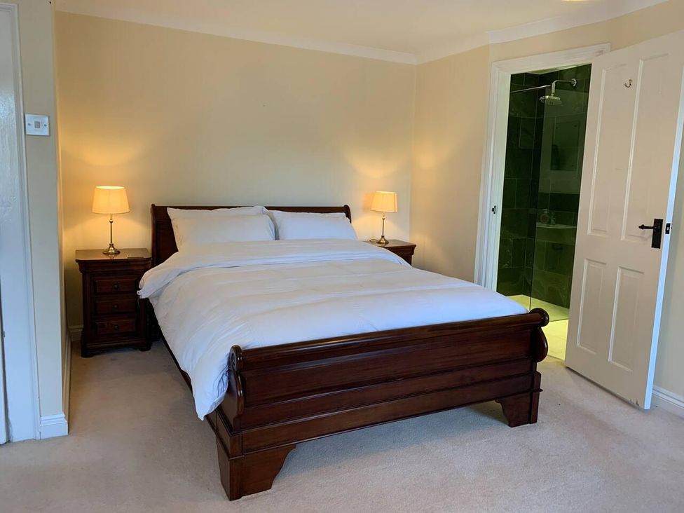 A bedroom with a bed and nightstand at House Sleeps 10 Pet friendly Parking in Caldbeck