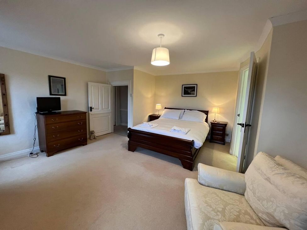 A bedroom with a bed and dresser at House Sleeps 10 Pet friendly Parking in Caldbeck