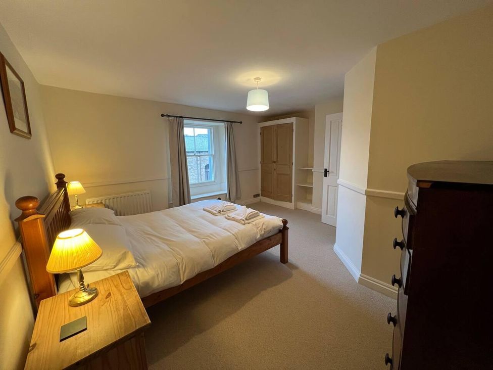 A bedroom with a bed and wardrobe at House Sleeps 10 Pet friendly Parking in Caldbeck
