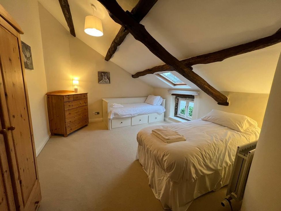 A bedroom with a bed and chest of drawers at House Sleeps 10 Pet friendly Parking in Caldbeck