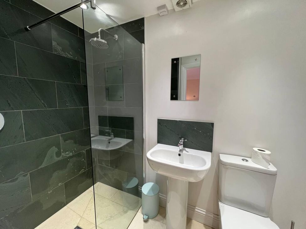 A bathroom with a shower, sink, and toilet at House Sleeps 10 Pet friendly Parking in Caldbeck