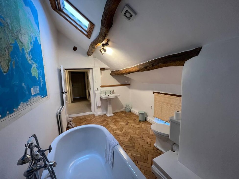 A bathroom with a bathtub and sink at House Sleeps 10 Pet friendly Parking in Caldbeck