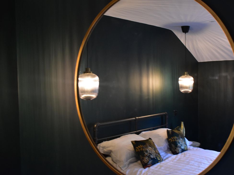A bedroom with a bed and bedside lights at Yr Hen Beudy Barn Conversion Sleeps 4 Dogs Ok near Brodle Farm near Llansteffan