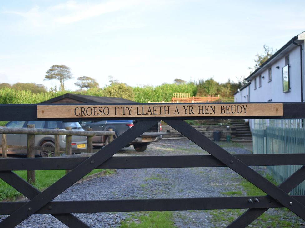 A gate with a sign at Yr Hen Beudy Barn Conversion Sleeps 4 Dogs Ok near Brodle Farm near Llansteffan