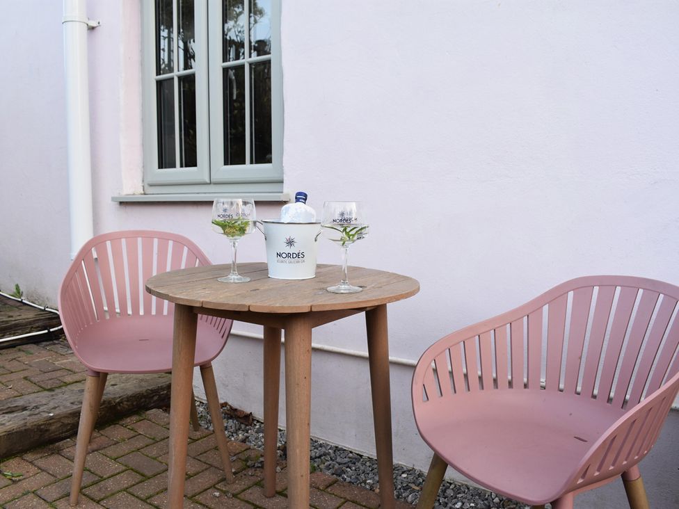 A table with chairs and drinks at Yr Hen Beudy Barn Conversion Sleeps 4 Dogs Ok in Broadle Farm near Llansteffan