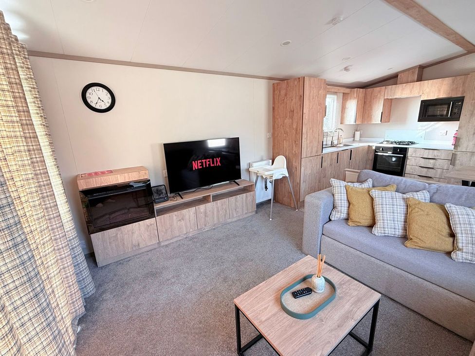 A living room with a television and sofa at 3Bed Sleeps 6 Parking Balcony Flamingo Land Resort near Kirkby Misperton