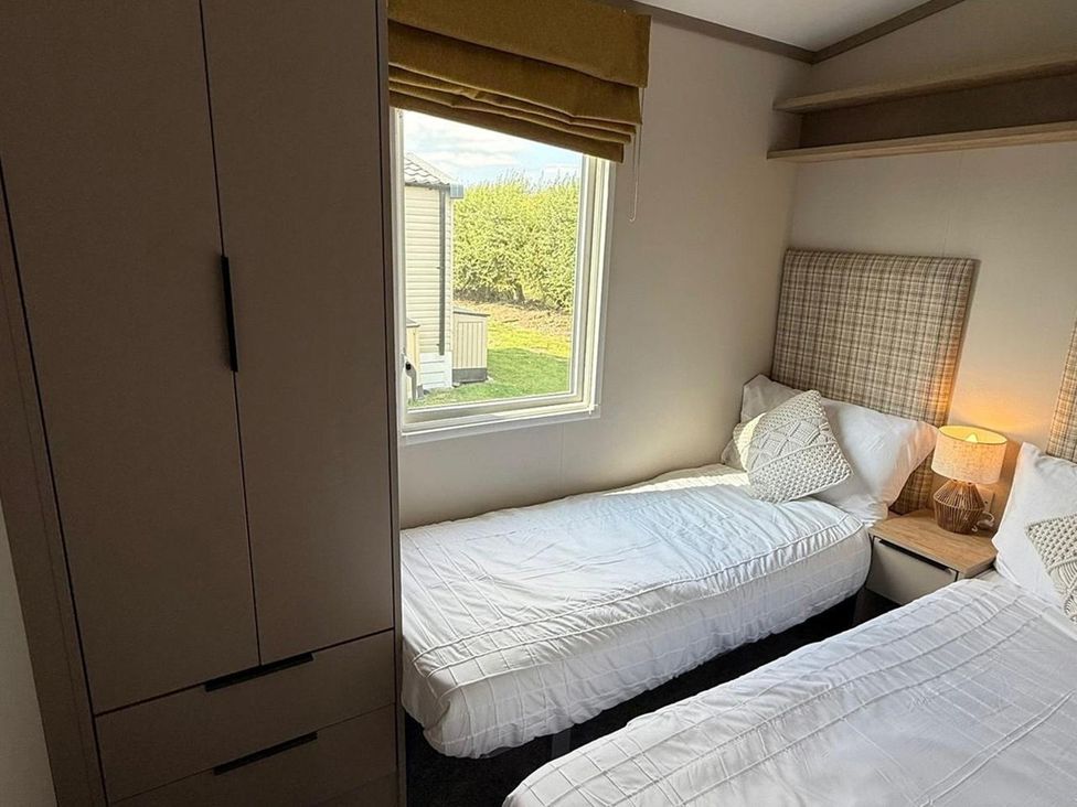 A bedroom with two beds and a window at 3Bed Sleeps 6 Parking Balcony Flamingo Land Resort near Kirkby Misperton