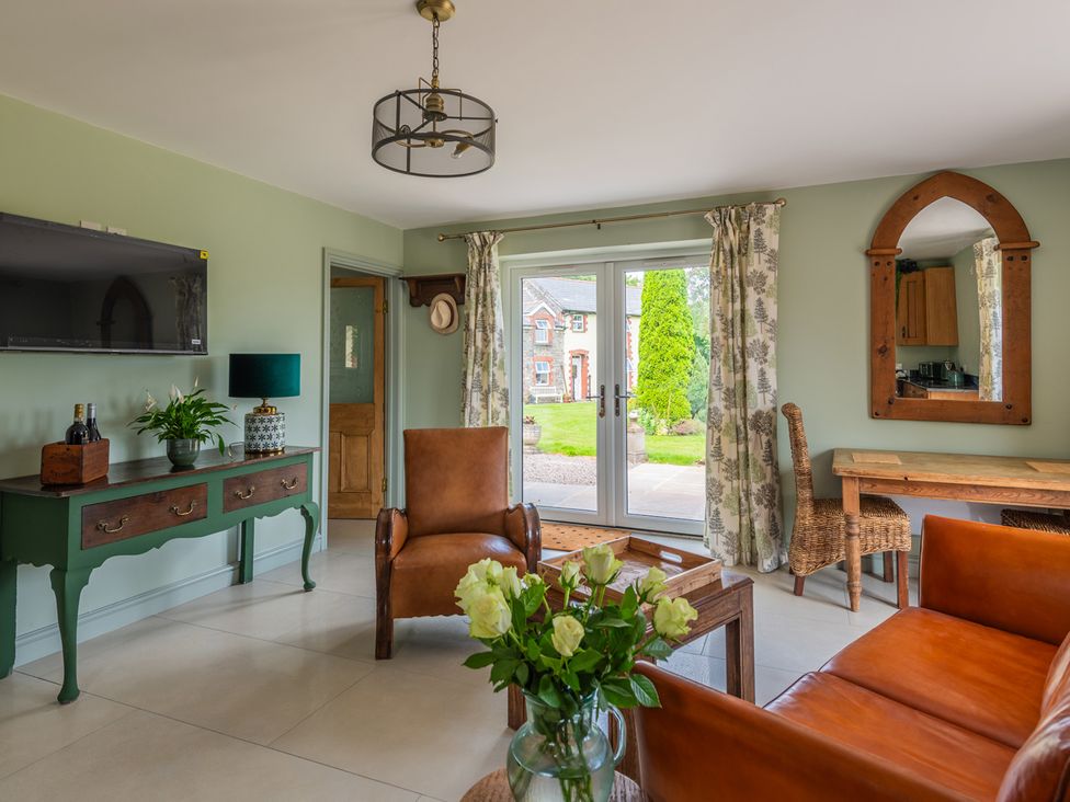 A living room with a sofa and chair at Paddock View Barn 1Bed Sleeps 4 with Parking near Duffryn Lloff Farm