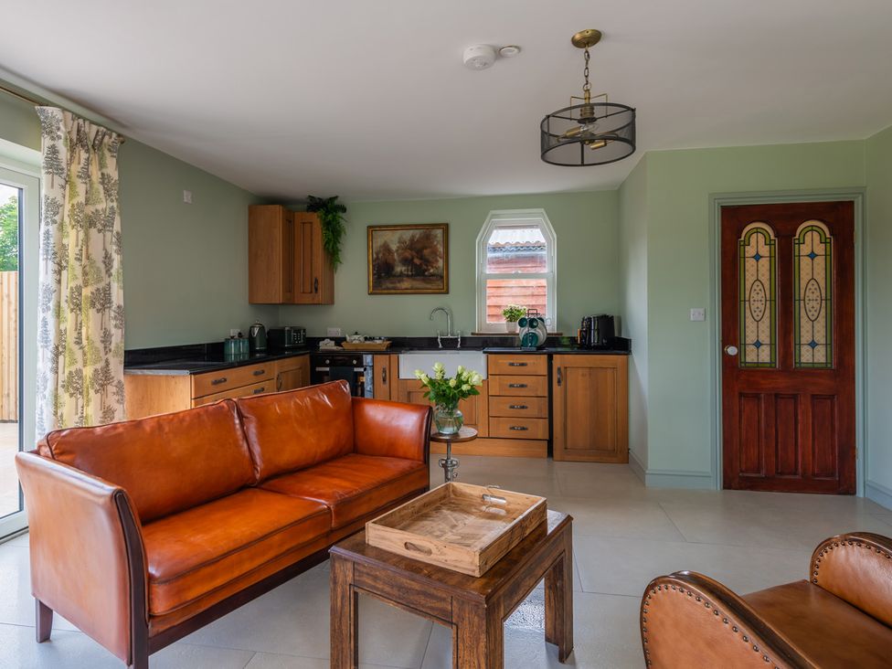 A living room with a sofa and coffee table at Paddock View Barn 1Bed Sleeps 4 with Parking near Duffryn Lloff Farm near Cowbridge