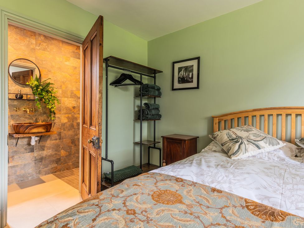 A bedroom with a bed and en-suite bathroom at Paddock View Barn 1Bed Sleeps 4 with Parking, Duffryn Lloff Farm near Cowbridge