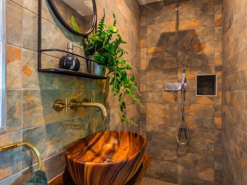 A bathroom with a wooden sink and shower at Paddock View Barn 1Bed Sleeps 4 with Parking, Duffryn Lloff Farm near Cowbridge