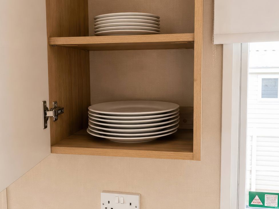 A cupboard with stacked plates at a property