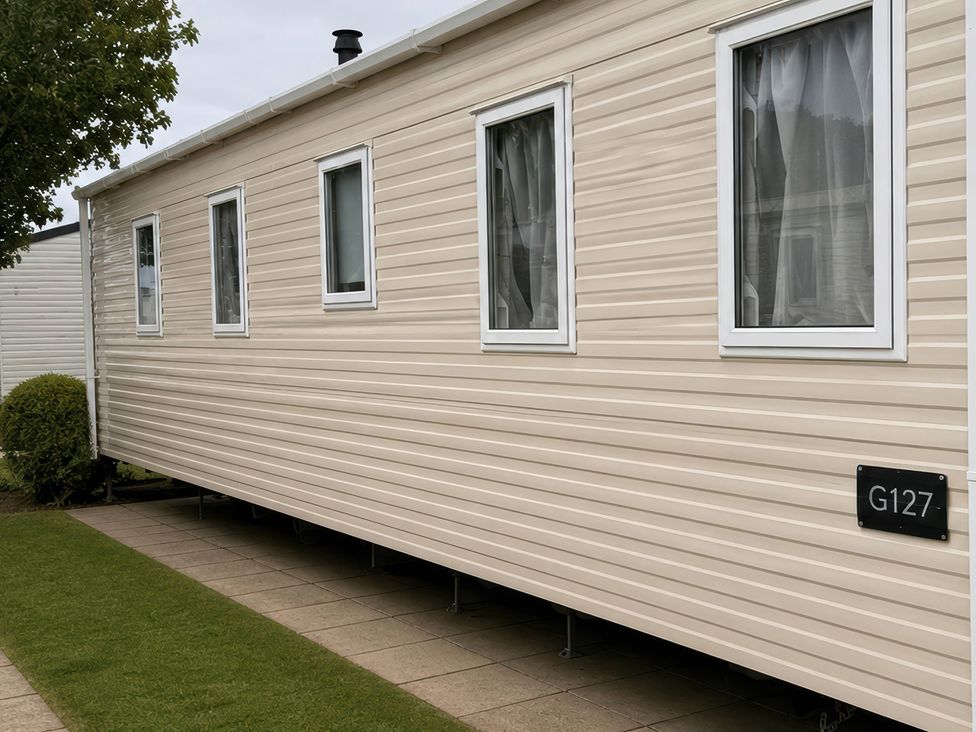 A mobile home with multiple windows at G127