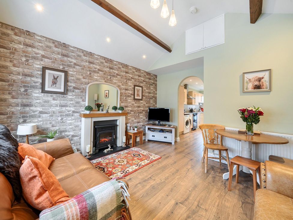 A living room with a sofa and fireplace at Central Ripon Sleeps 3 Garden Pet Friendly in Ripon