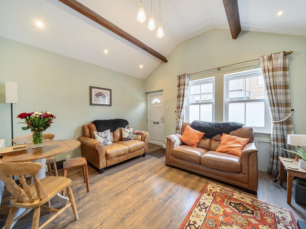 A living room with sofas and a table at Central Ripon Sleeps 3 Garden Pet Friendly, Ripon