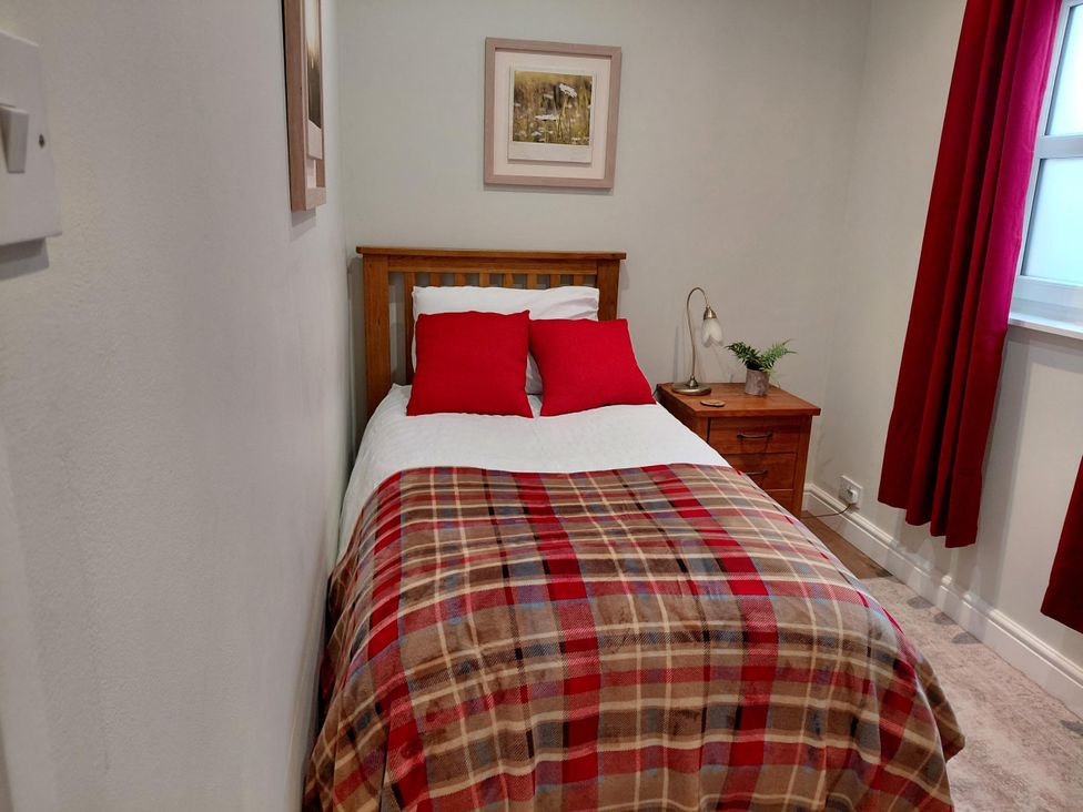 A bedroom with a bed and nightstand at Central Ripon Sleeps 3 Garden Pet Friendly in Ripon