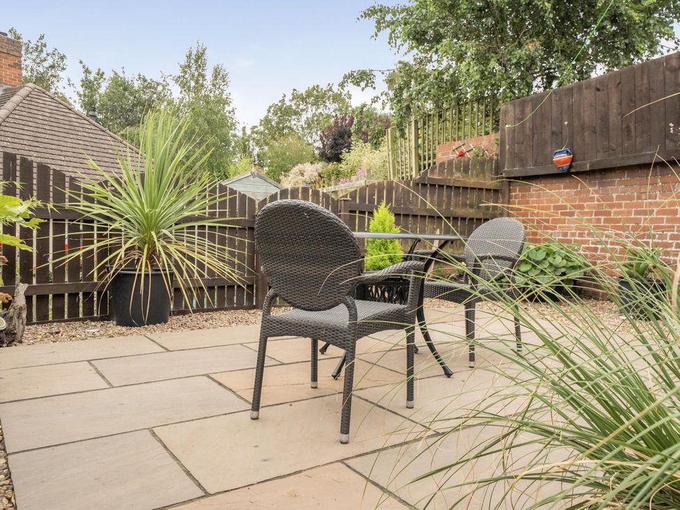 A garden with paving stones, chairs, and plants at Central Ripon Sleeps 3 Garden Pet Friendly, Ripon