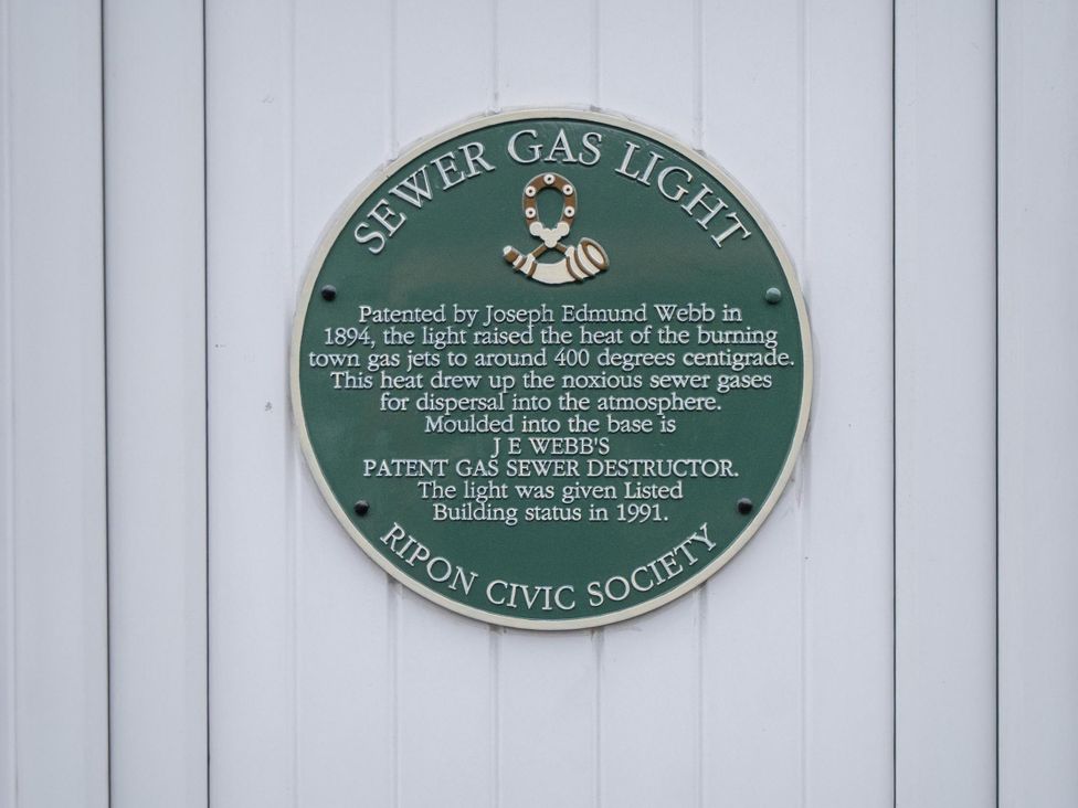 A plaque about sewer gas light history at Central Ripon Sleeps 3 Garden Pet Friendly Ripon
