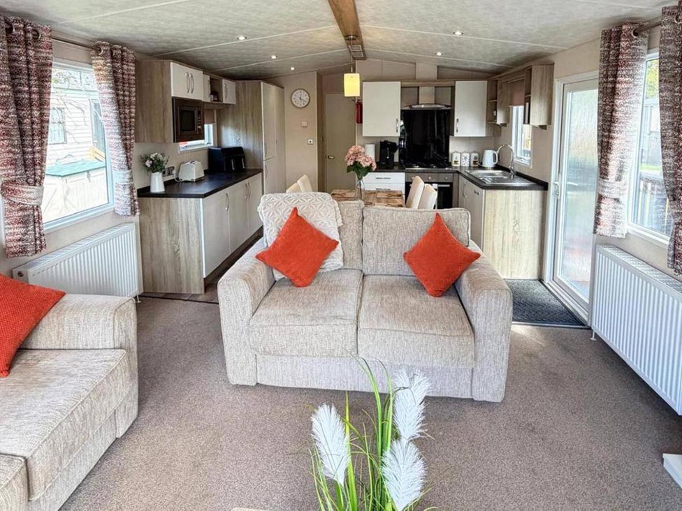 A living room with a sofa and kitchen unit at Lillardsedge Luxury Caravan Sleeps 6 with Parking Lilliardsedge Holiday Park near St Boswells