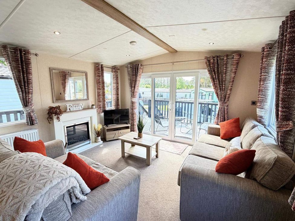 A living room with a sofa and coffee table at Lillardsedge Luxury Caravan Sleeps 6 with Parking, Lilliardsedge Holiday Park near St Boswells