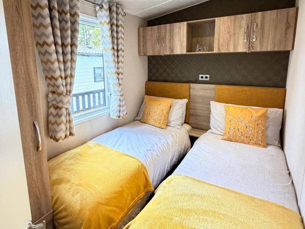 A bedroom with two beds and window at Lillardsedge Luxury Caravan Sleeps 6 with Parking near Lilliardsedge Holiday Park