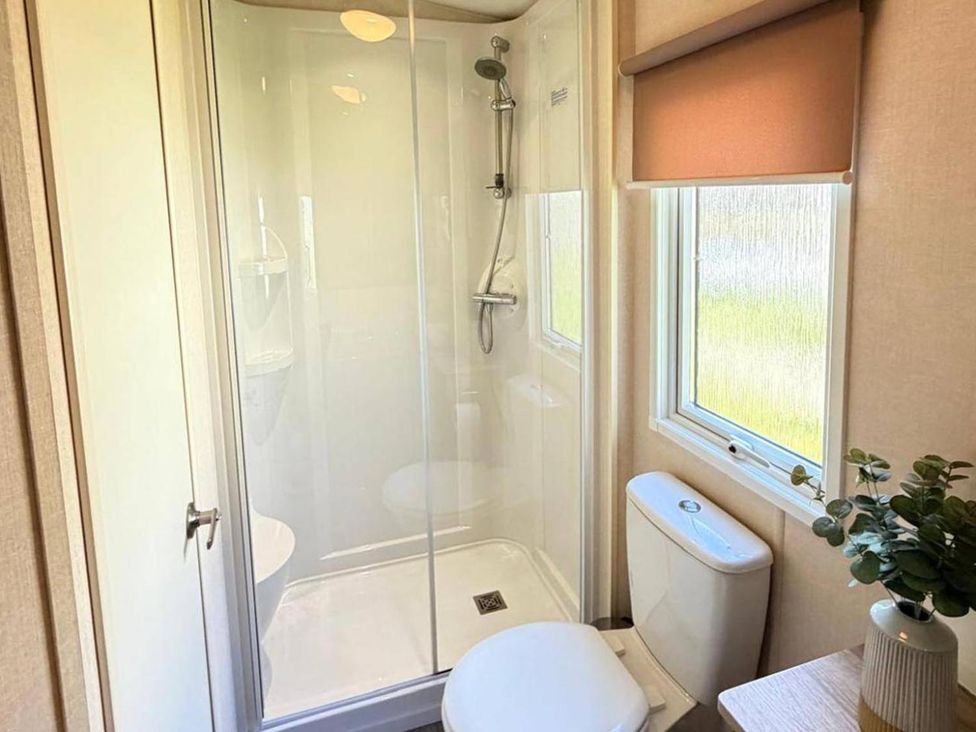 A bathroom with a shower and toilet at Lillardsedge Luxury Caravan Sleeps 6 with Parking near Lilliardsedge Holiday Park