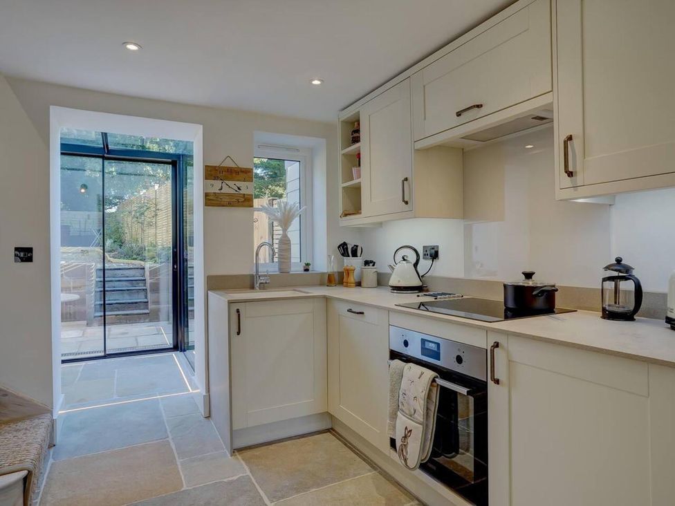 A kitchen with appliances and a window at 1 Bed Cottage Sleeps 2 with Hot Tub Pets Welcome, Great Massingham