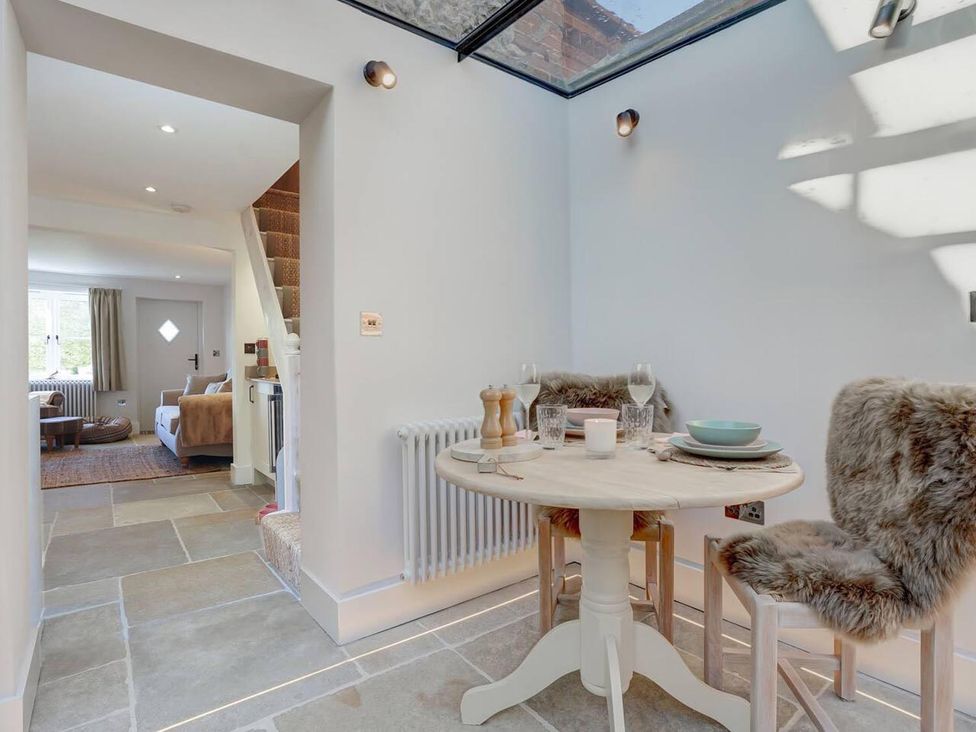 A dining area with a table and chairs at 1 Bed Cottage Sleeps 2 with Hot Tub Pets Welcome in Great Massingham