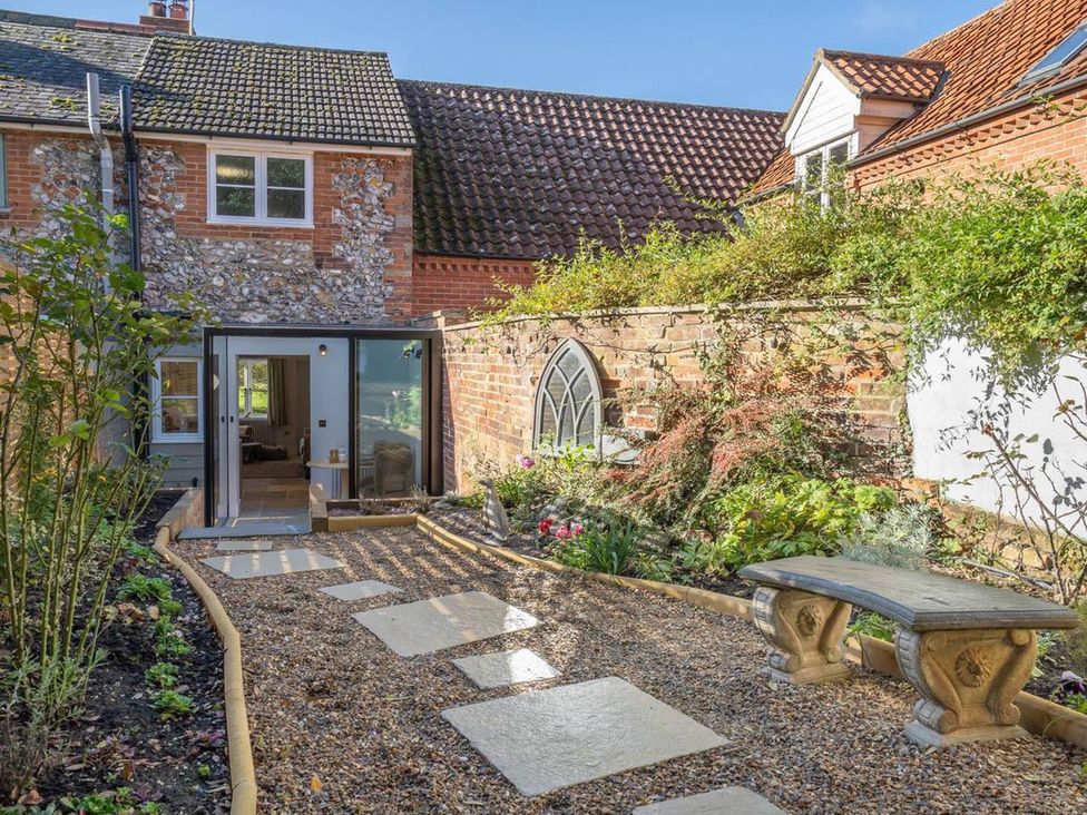 A garden with a pathway and seating area at 1 Bed Cottage Sleeps 2 with Hot Tub Pets Welcome in Great Massingham